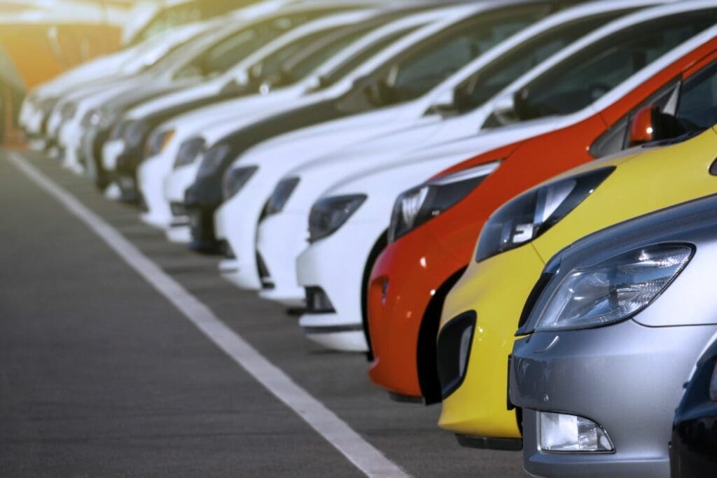 Courtesy Cars parked in a row outside a vehicle repair centre (or bodyshop)