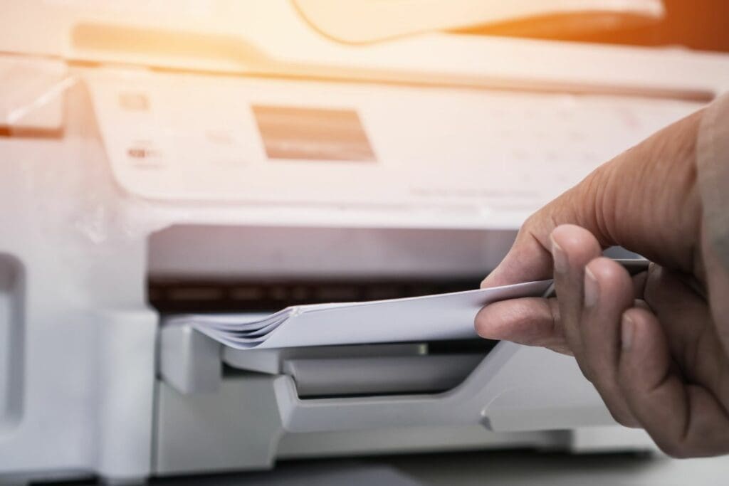 A bodyshop manager printing off an invoice for a customer, due to the fact their bodyshop system can't handle paperless processes